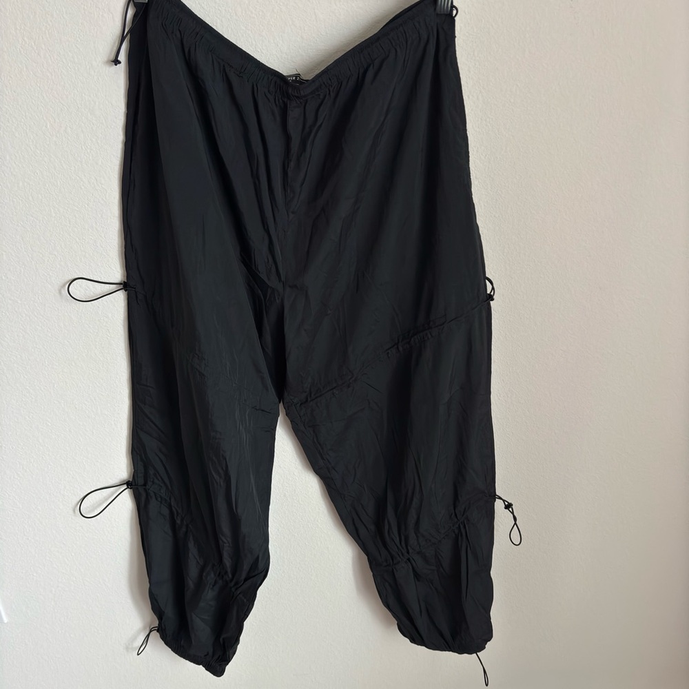 Black Cargo Pants with Adjustable Leg Openings and Elastic Waistband